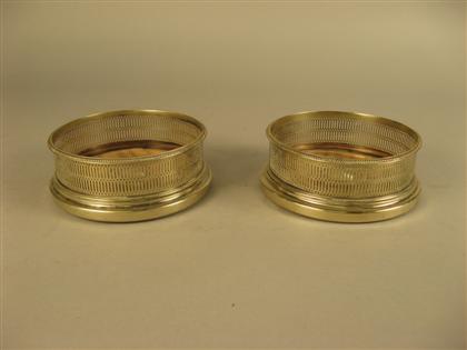 Appraisal: Pair of silver plate wine coasters With pierced rims Diam