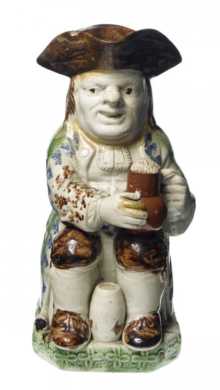 Appraisal: A PEARLWARE TOBY JUG STAFFORDSHIRE OR YORKSHIRE the seated toper