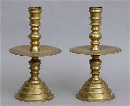 Appraisal: PAIR OF CONTINENTAL BAROQUE-STYLE BRASS CANDLESTICKS Each bobbin-turned stem with