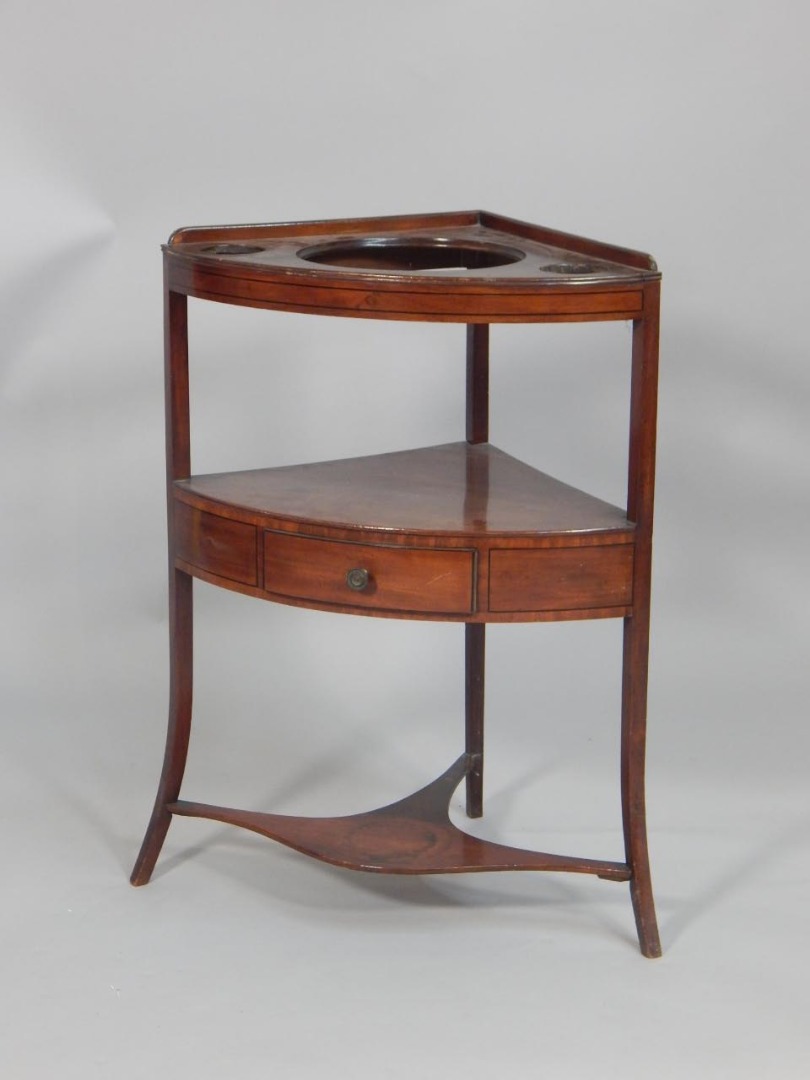 Appraisal: An early thC mahogany and ebony strung corner washstand the