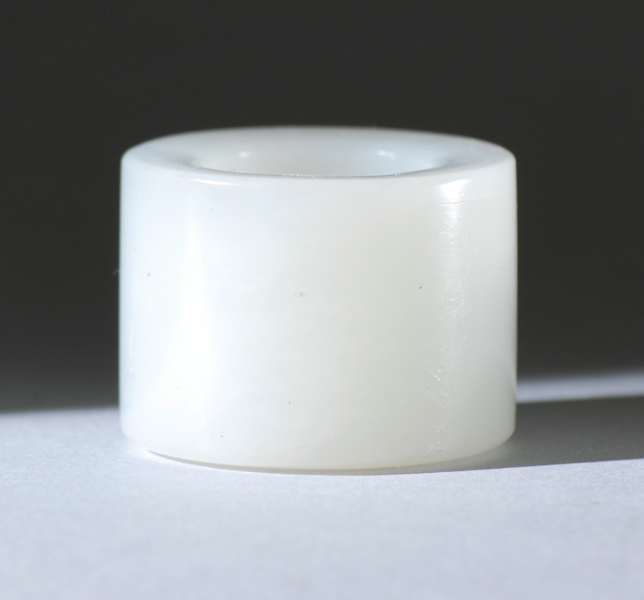 Appraisal: PURE WHITE JADE ARCHER'S RING th CenturyIn simple cylinder form