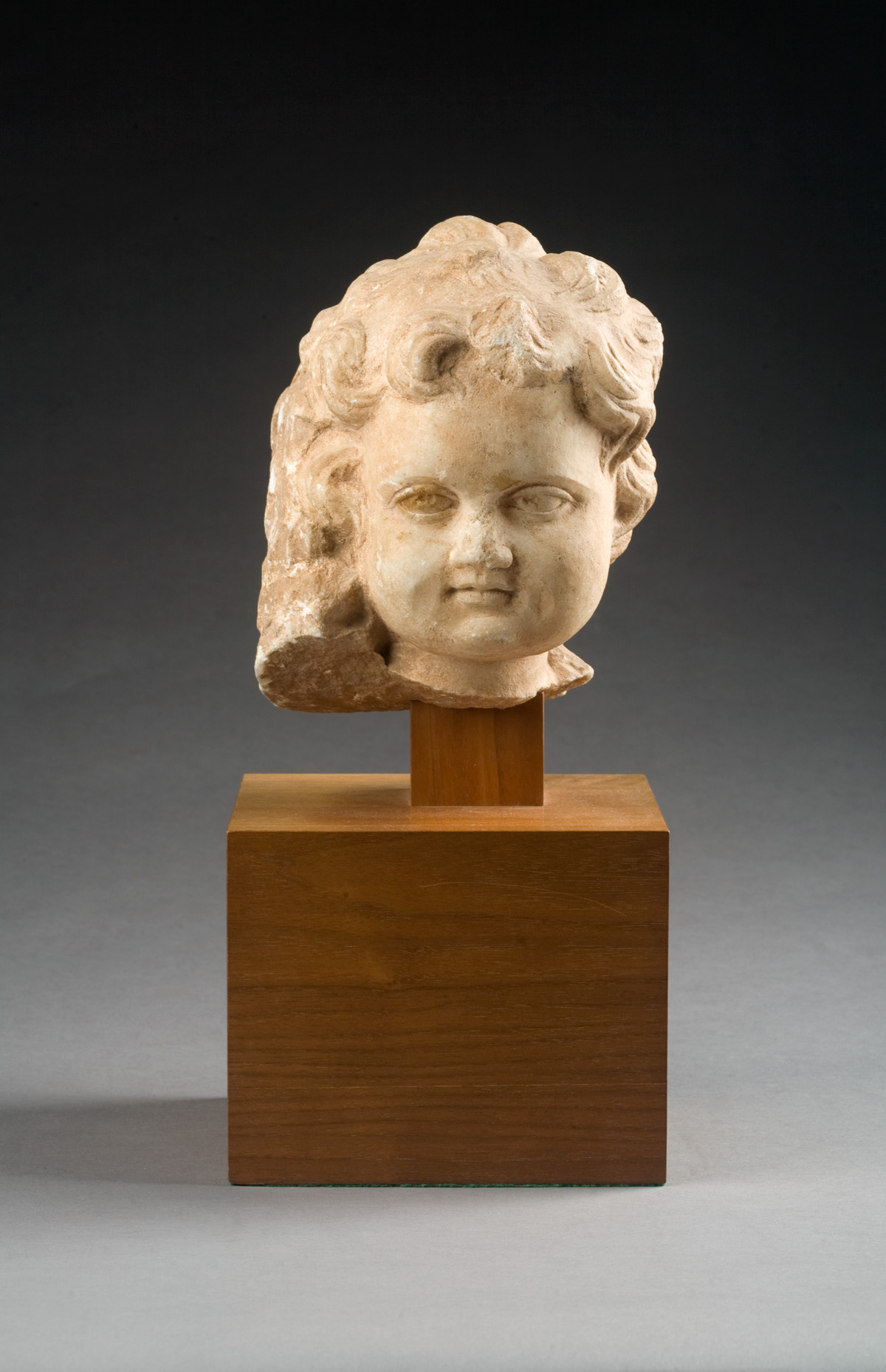 Appraisal: CARVED WHITE MARBLE HEAD OF A YOUNG CHILD Mounted on