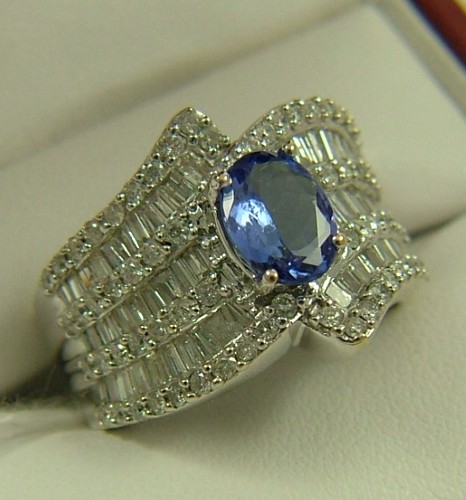 Appraisal: TANZANITE DIAMOND AND FOURTEEN KARAT GOLD RING centering an oval-cut