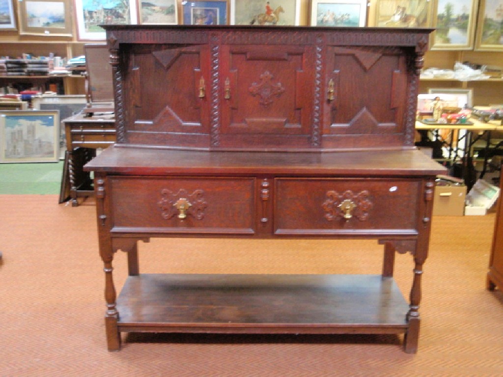 Appraisal: A 's oak buffet sideboard the top section enclosed by