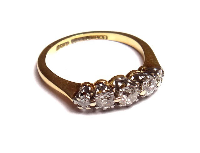 Appraisal: A gold and platinum diamond set five stone ring claw