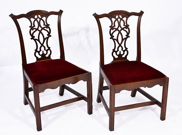 Appraisal: A PAIR OF GEORGE III MAHOGANY DINING CHAIRS with scroll