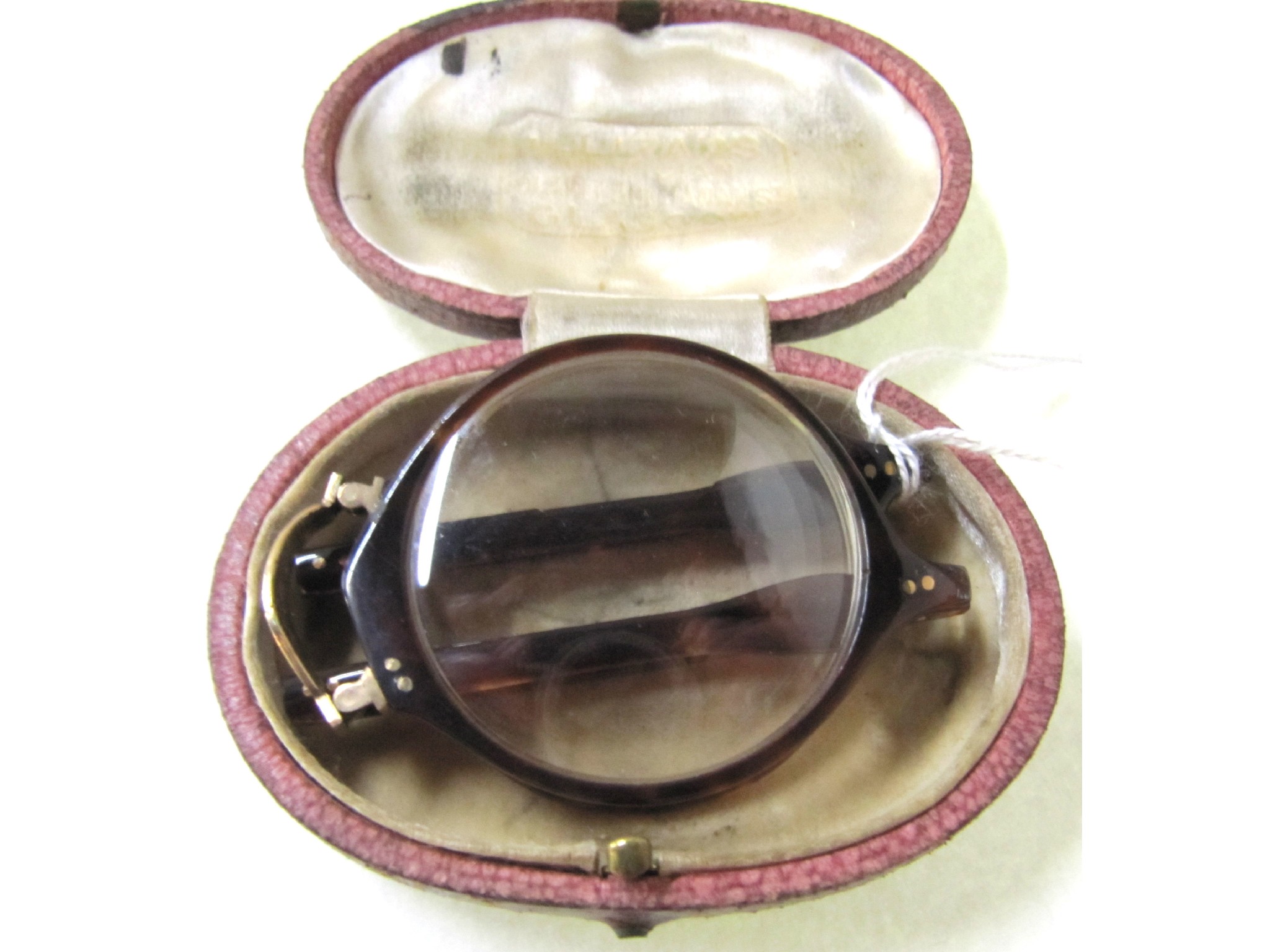 Appraisal: A cased pair of tortoiseshell framed folding spectacles