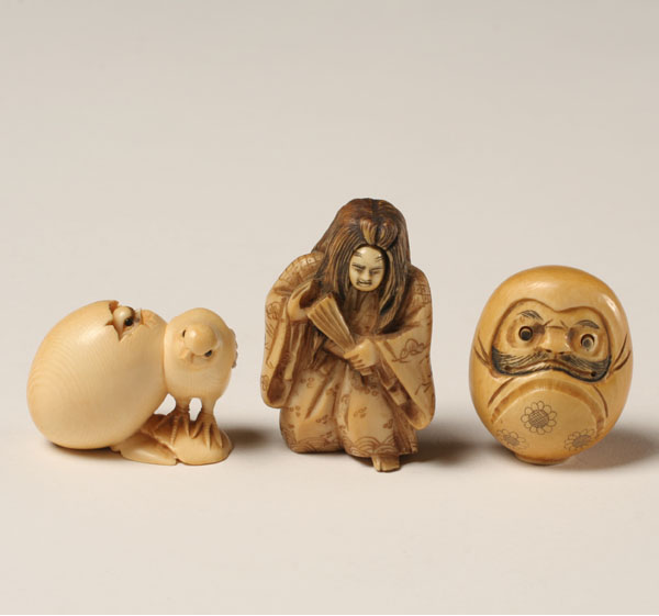 Appraisal: Japanese carved ivory netsukes rotating face chicks and scary face