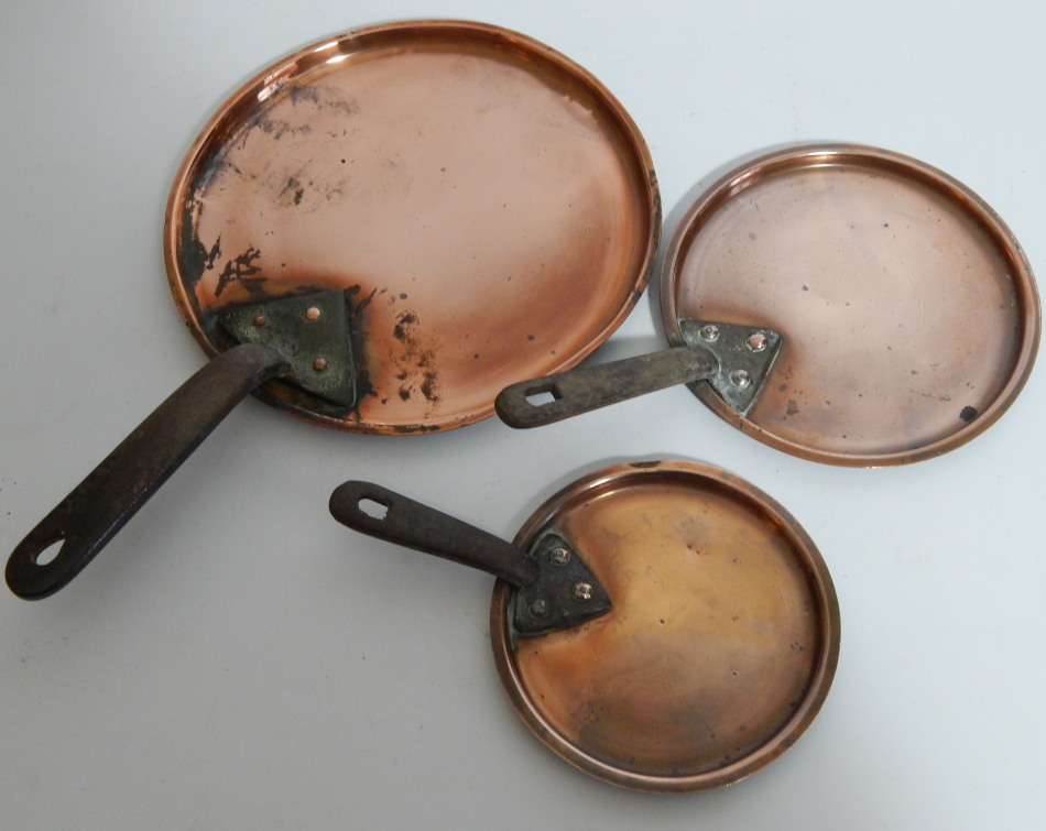 Appraisal: A graduated set of three Victorian copper saucepan covers cm