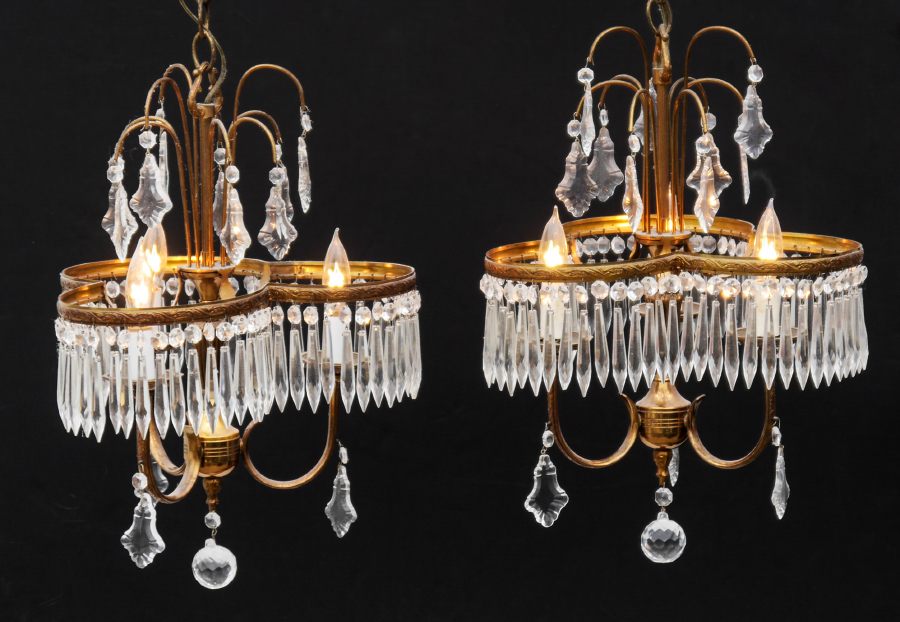 Appraisal: PAIR OF PETITE CRYSTAL CHANDELIERS light gilt brass frame with