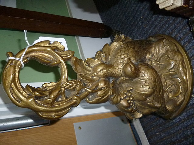 Appraisal: A CAST GILT METAL DOOR PORTER in the form of