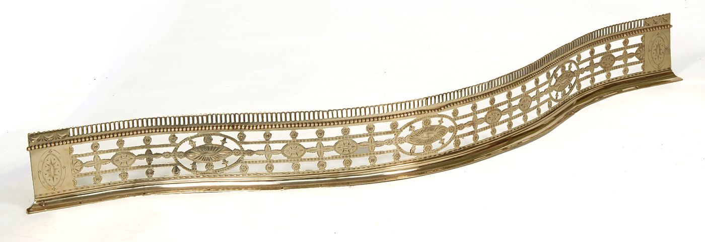 Appraisal: SERPENTINE-FORM BRIGHT-CUT BRASS FIRE FENDER th CenturyWith openwork floral design