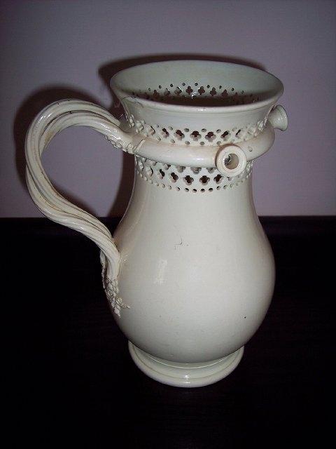 Appraisal: An th Century creamware puzzle jug the pierced neck above