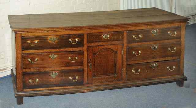 Appraisal: AN TH CENTURY OAK DRESSER BASE having three long drawers