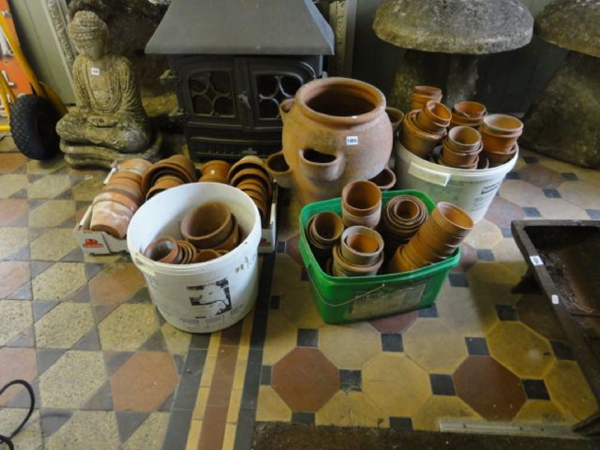 Appraisal: A terracotta strawberry pot together with a quantity of small