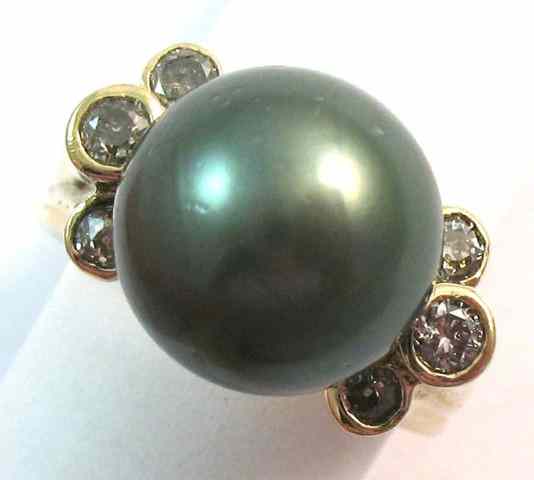 Appraisal: BLACK PEARL AND DIAMOND RING k yellow gold featuring a