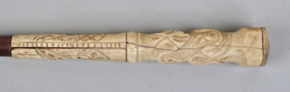 Appraisal: Carved Whalebone Cane with naive folk carved grip and mahogany