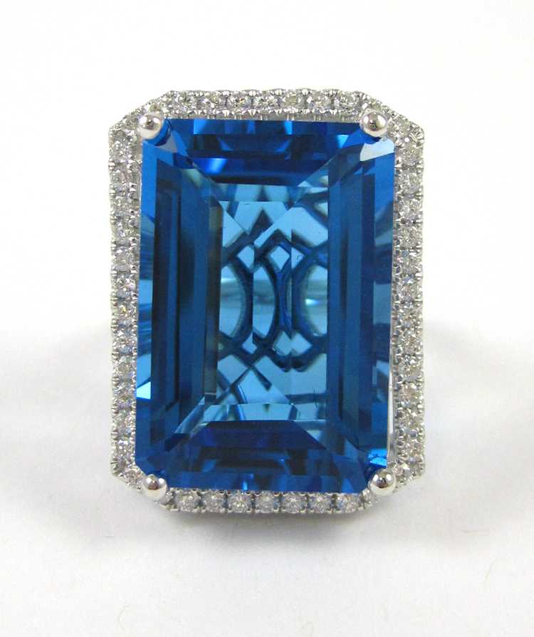 Appraisal: BLUE TOPAZ AND FOURTEEN KARAT WHITE GOLD RING with round-cut