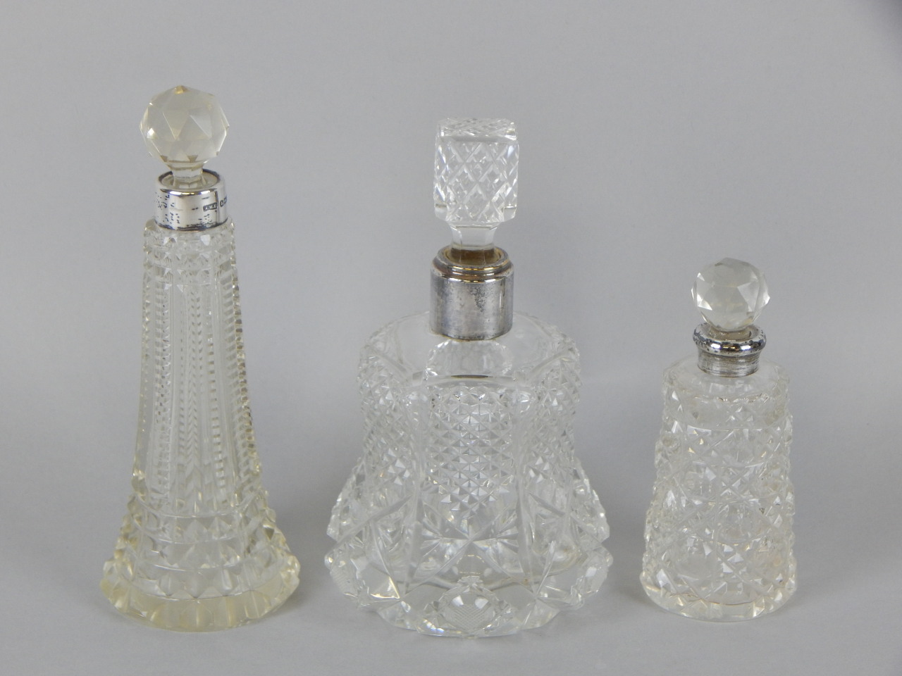 Appraisal: Three cut glass scent bottles each with a faceted knop