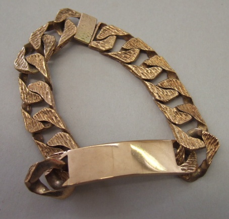 Appraisal: A ct gold bark textured flat curb link identity bracelet