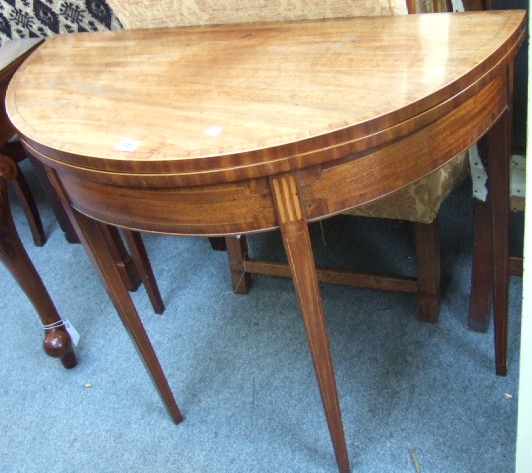 Appraisal: A George III mahogany and line inlaid demi-lune tea table