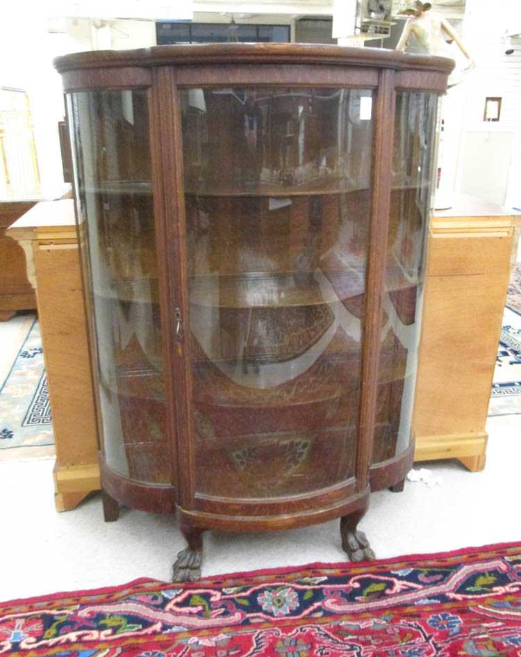 Appraisal: AN OAK AND CURVED GLASS CHINA DISPLAY CABINET American late