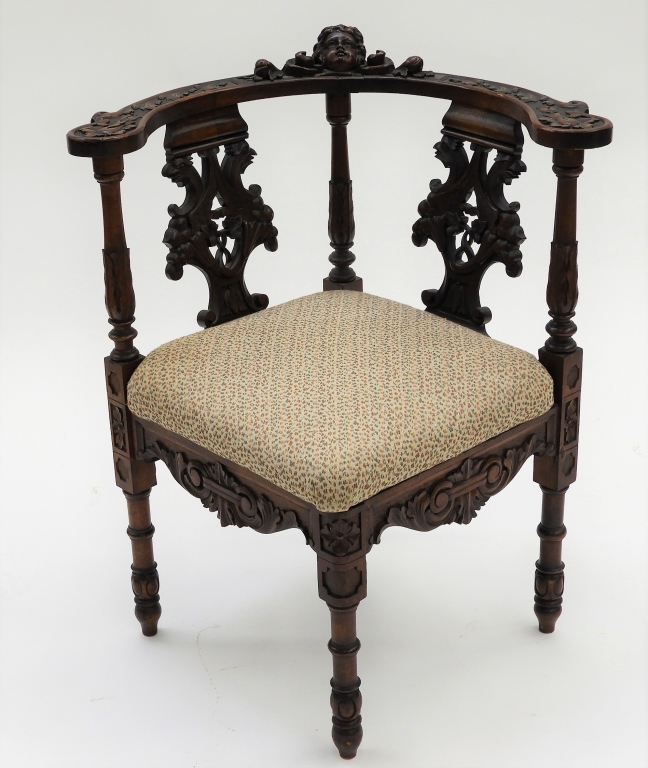 Appraisal: C ORNATELY CARVED CORNER CHAIR Europe Late th CenturyContinuous arm