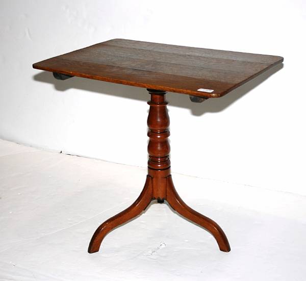 Appraisal: A late George III oak tilt top tea table height