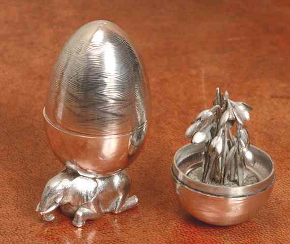 Appraisal: A SILVER EGG with textured finish containing a bunch of