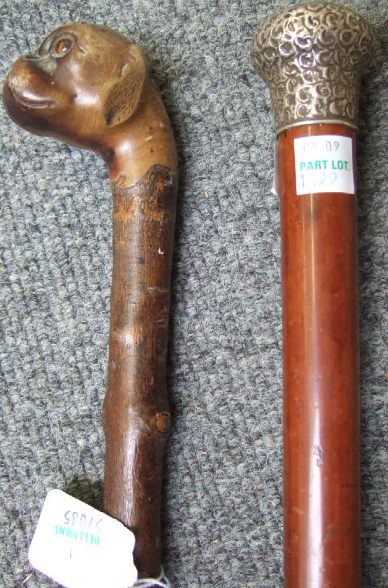 Appraisal: A Victorian hazelwood walking cane the pommel carved as the