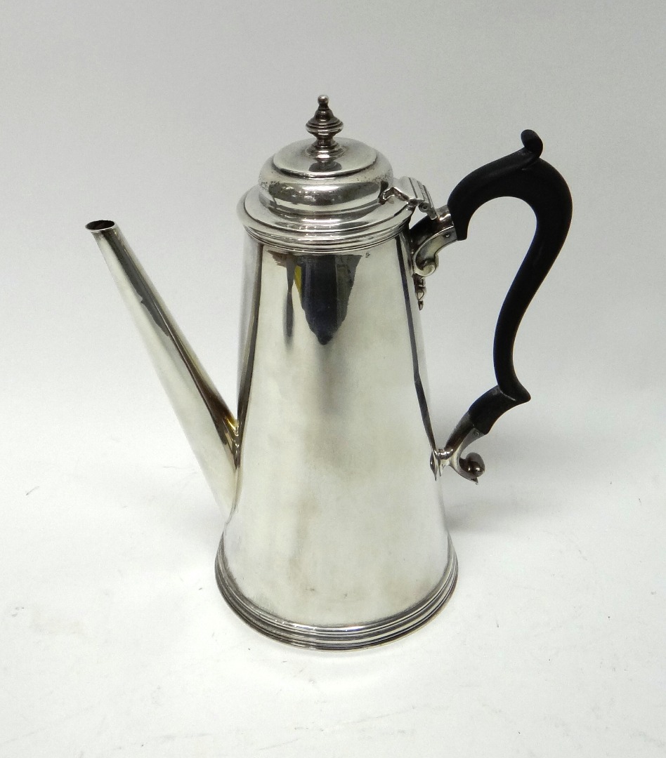 Appraisal: A silver teapot of tapering cylindrical form on a reeded