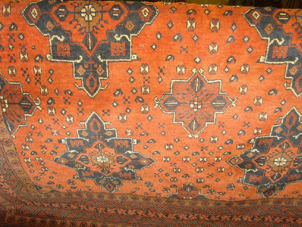 Appraisal: An eastern wool rug with repeating medallion decoration on a