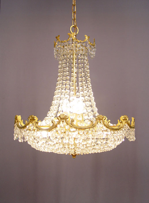 Appraisal: LIGHT GILT AND CRYSTAL CHANDELIER Gilt metal frame chain prisms