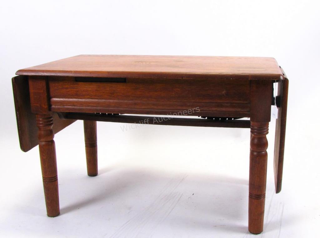 Appraisal: An antique physician's examination table oak with hinged head and