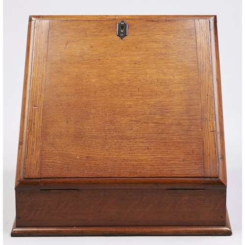 Appraisal: An Edwardian oak slope front stationery box with fitted interior