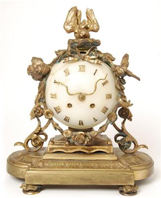 Appraisal: A French gilt brass and onyx mantel clock with an