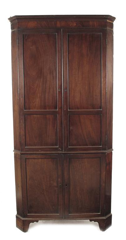 Appraisal: An early th century mahogany standing corner cupboard