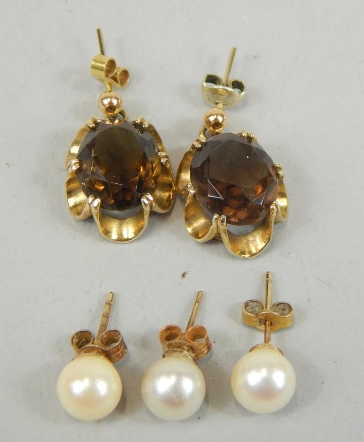 Appraisal: A pair of smokey quartz set earrings and three pearl