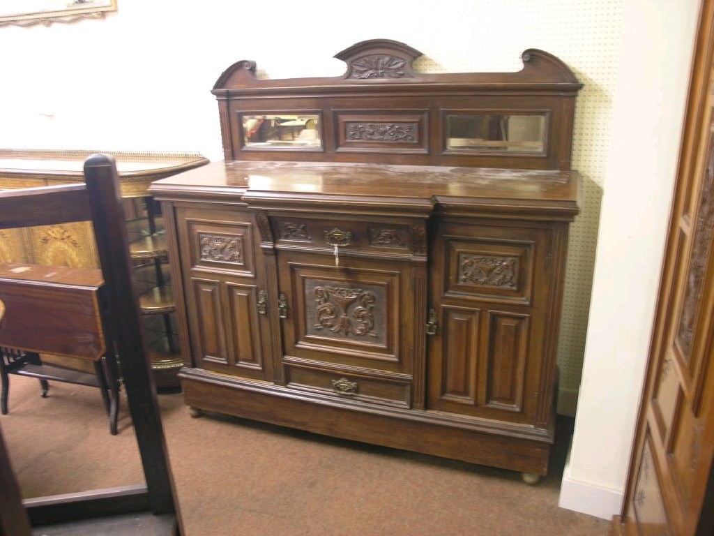 Appraisal: A late Victorian walnut sideboard raised back with carved detail