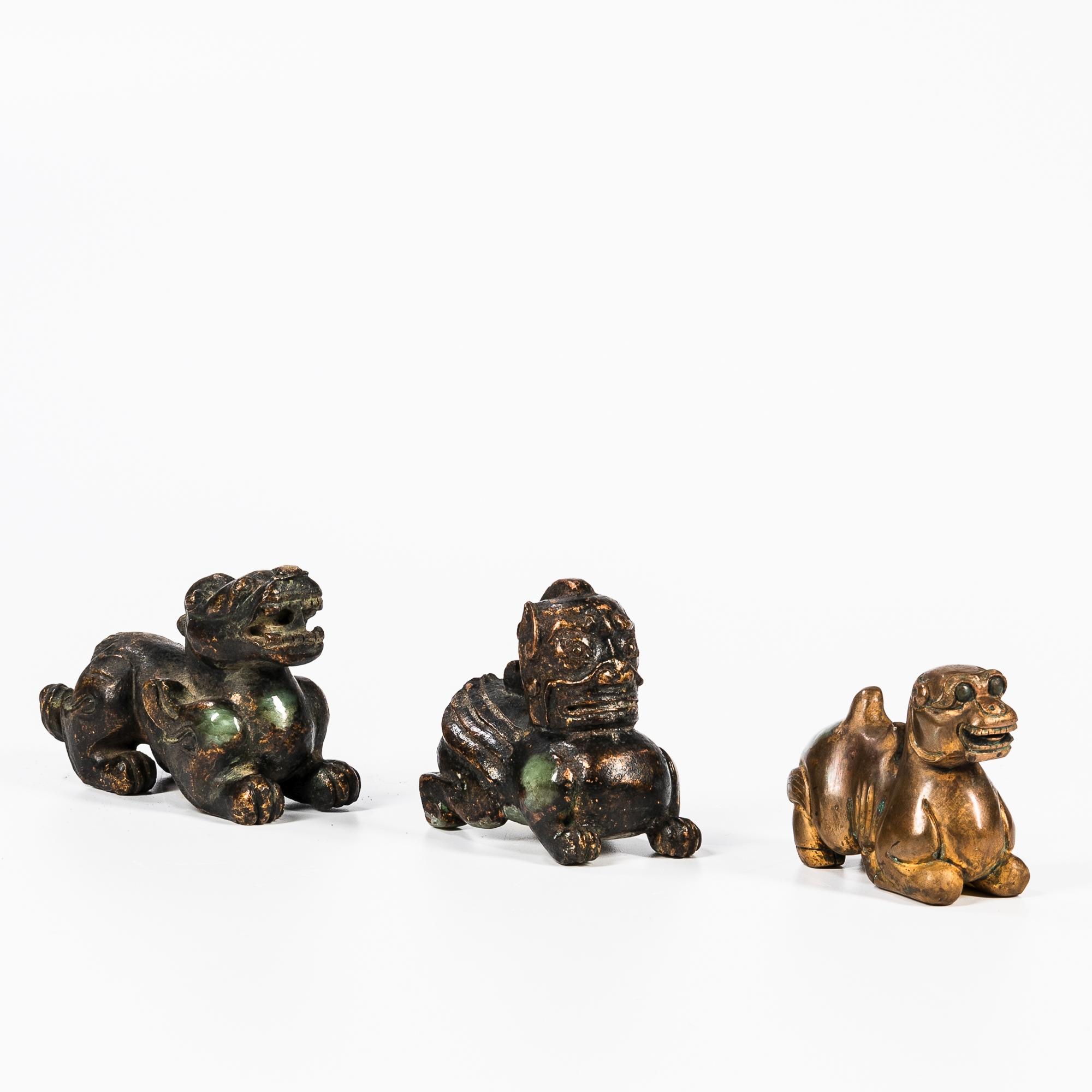 Appraisal: THREE HARDSTONE CARVINGS OF MYTHICAL ANIMALS China coated with liquid