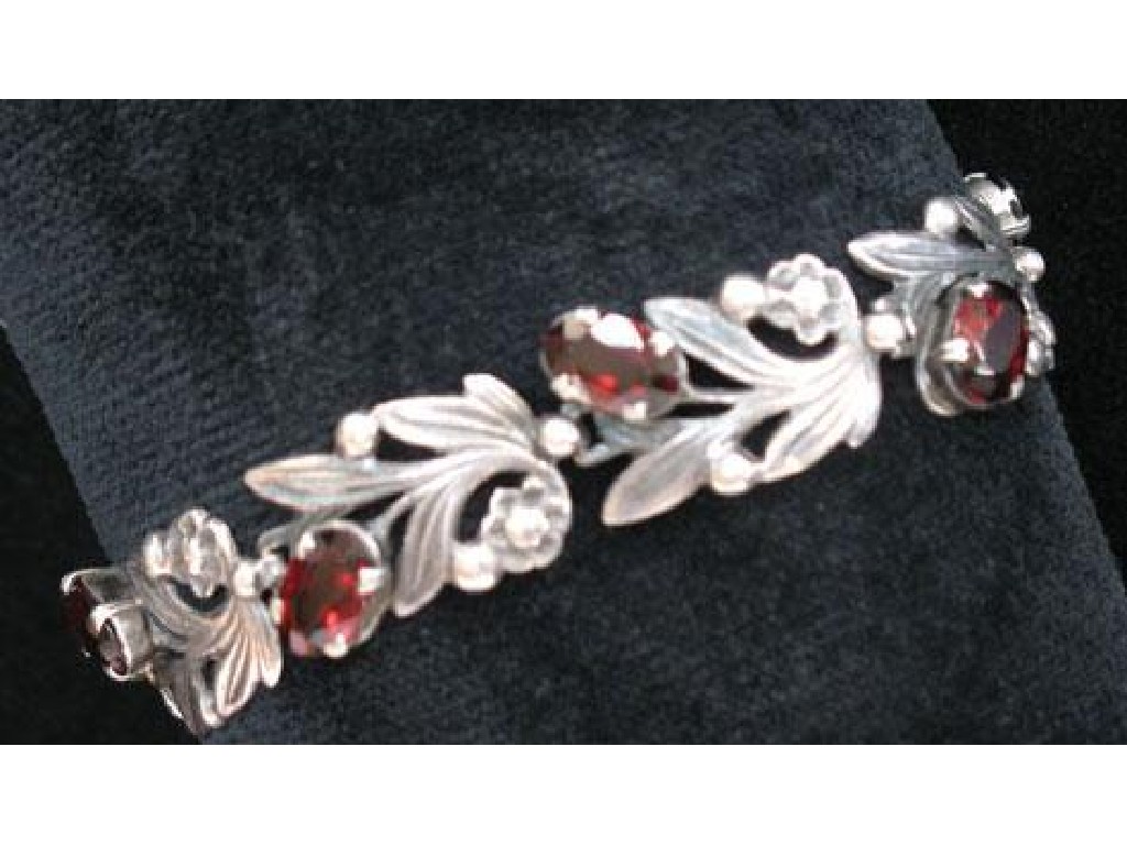 Appraisal: BERNARD INSTONE A SILVER AND GARNET BRACELET each link in