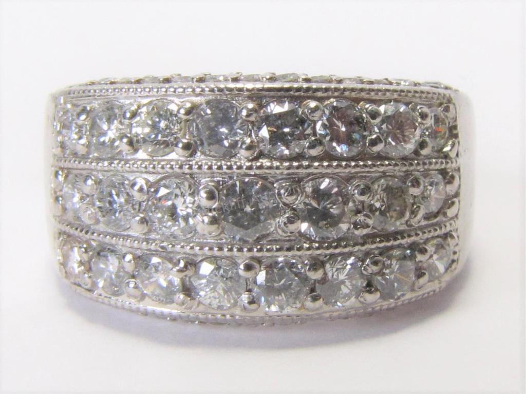 Appraisal: A platinum band with three rows of twenty-three nice round