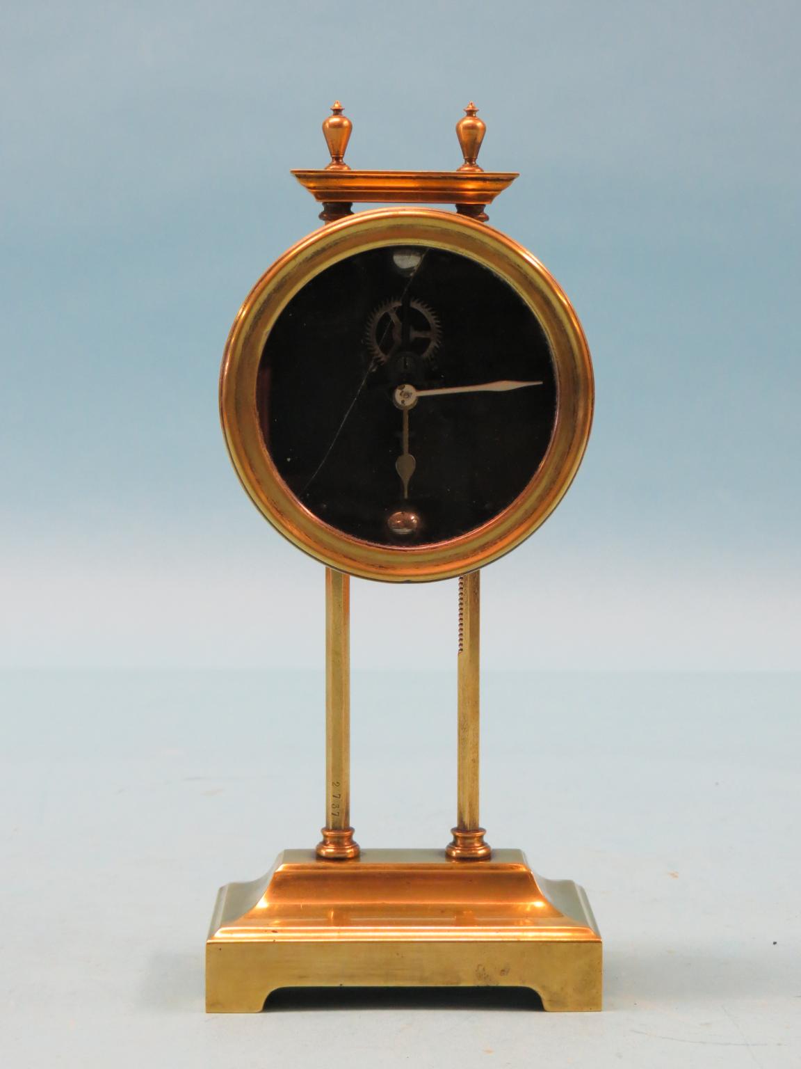 Appraisal: A brass gravity mantel timepiece circular dial with visible escapement