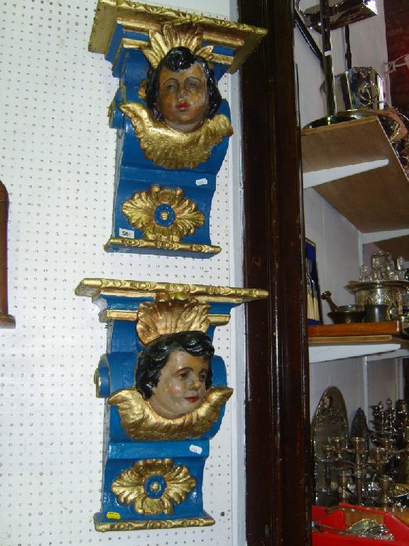 Appraisal: A pair of carved wooden wall brackets with painted blue