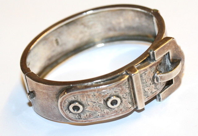 Appraisal: A VICTORIAN SILVER HINGED BANGLE in the form of a