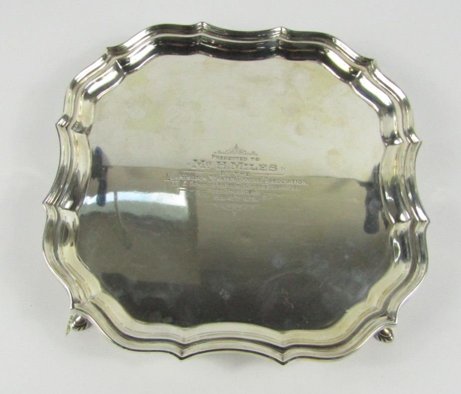 Appraisal: A George V silver presentation salver of shaped square design