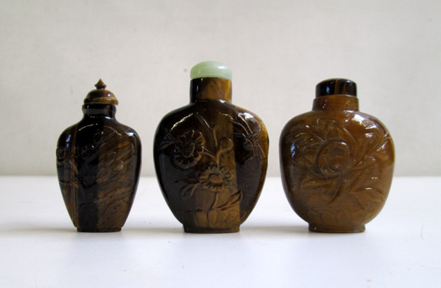 Appraisal: THREE CHINESE TIGER EYE SNUFF BOTTLES two having floral carved