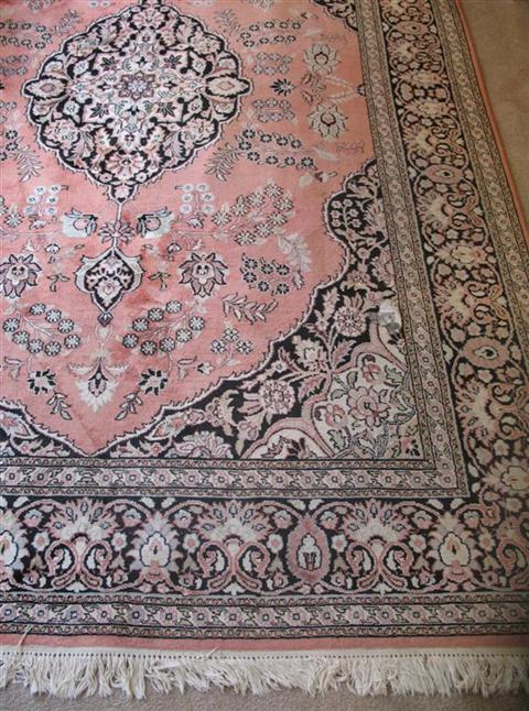 Appraisal: ORIENTAL SALMON AND CHOCOLATE BROWN CARPET Late th century with