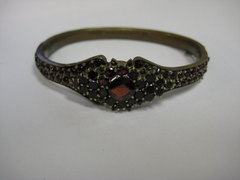 Appraisal: VICTORIAN GARNET BANGLE BRACELET A gold vermeil hinged bangle late