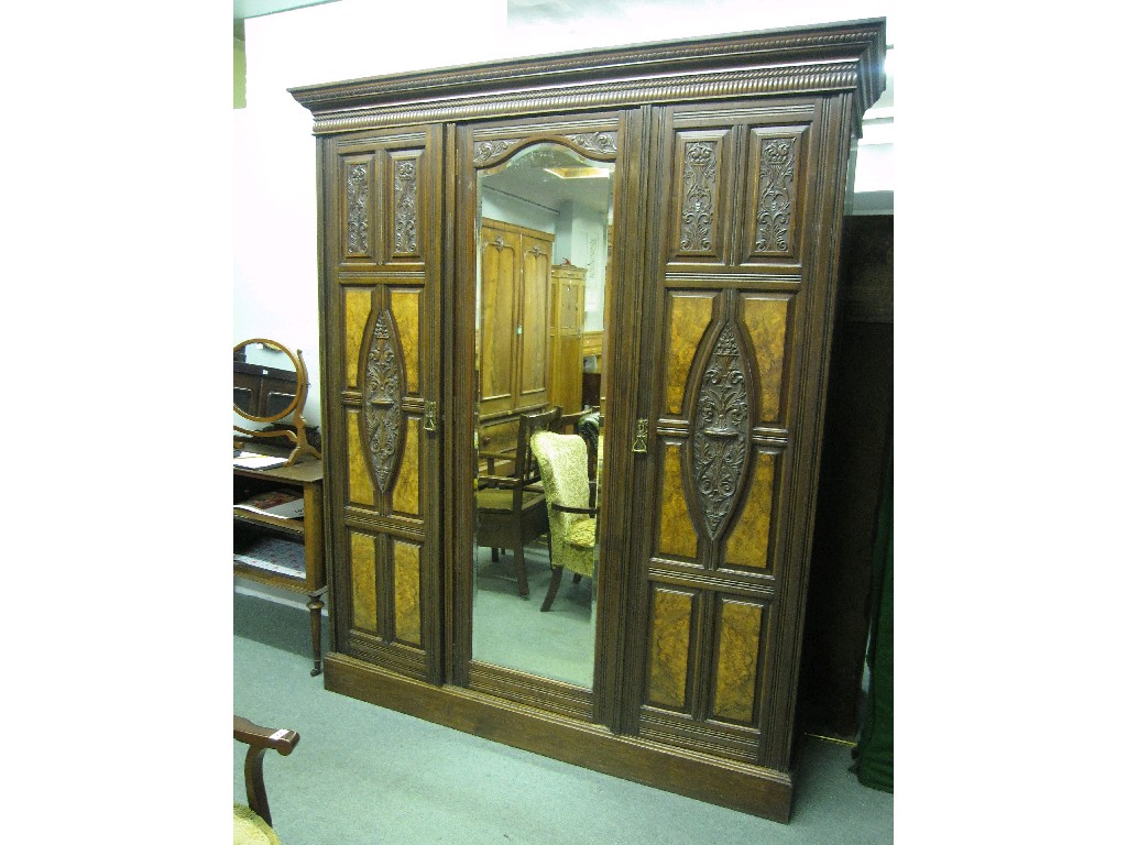 Appraisal: Victorian oak triple wardrobe with walnut veneered and carved doors